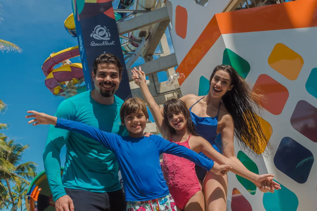 a imagem mostra uma família sorrindo no Aqua Park, que recebeu o prêmio de 2º melhor parque aquático do mundo